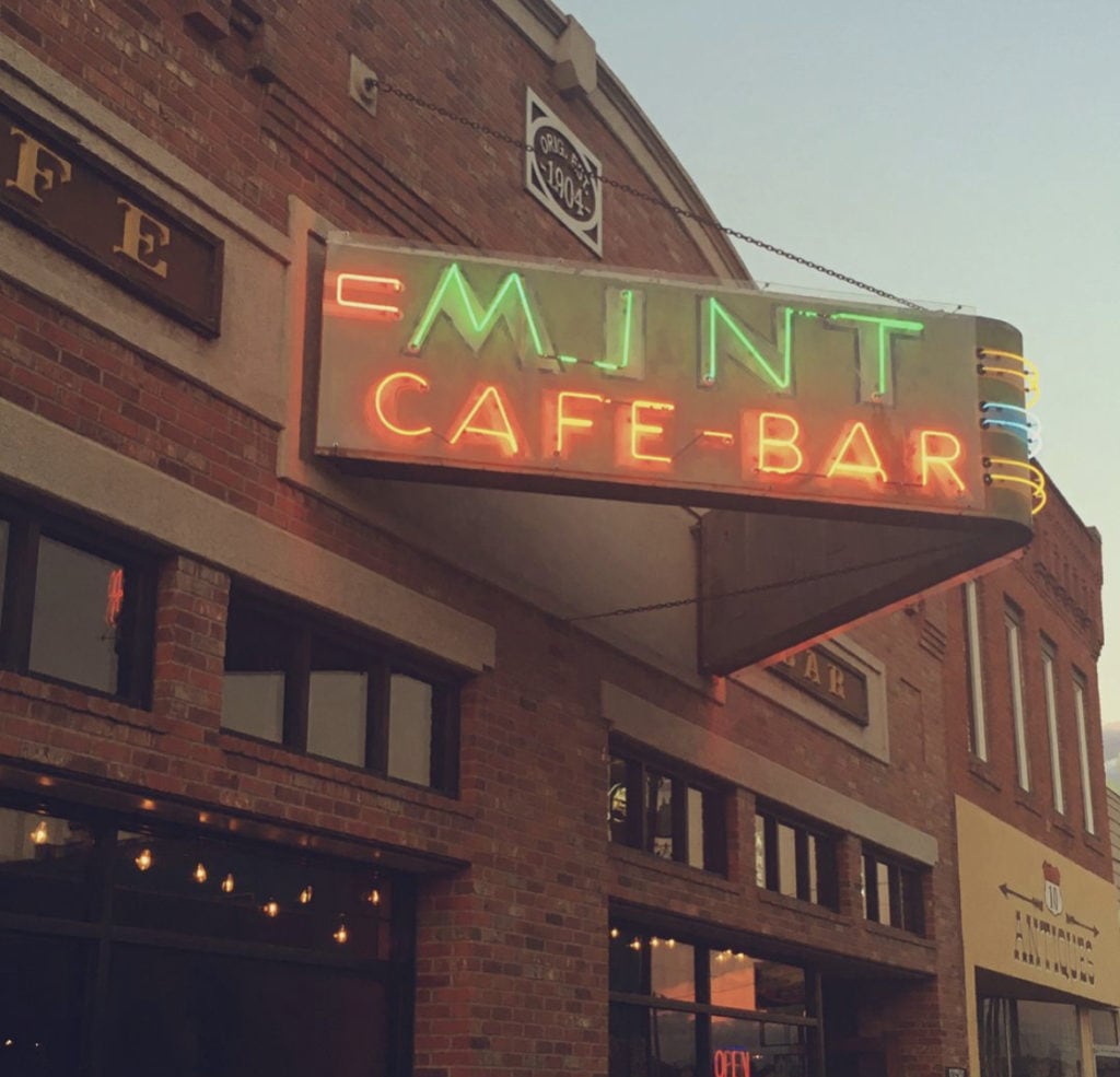 exterior and neon sign for the mint cafe and bar in downtown belgrade