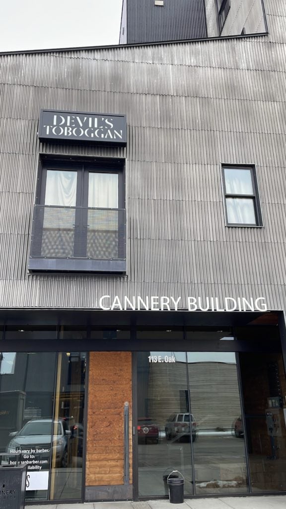 front exterior of the cannery building where the devil's toboggan speakeasy-style bar in bozeman is located