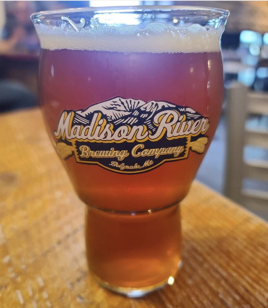 glass of beer inside of madison river brewing company