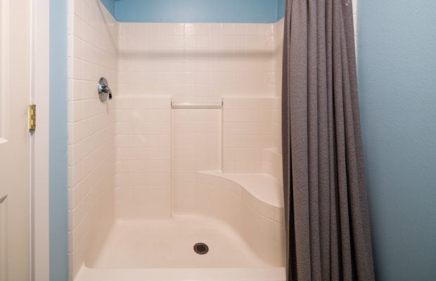 79 Starlight Drive ensuite bathroom to bedroom #2 with shower and tub. walls are painted blue.