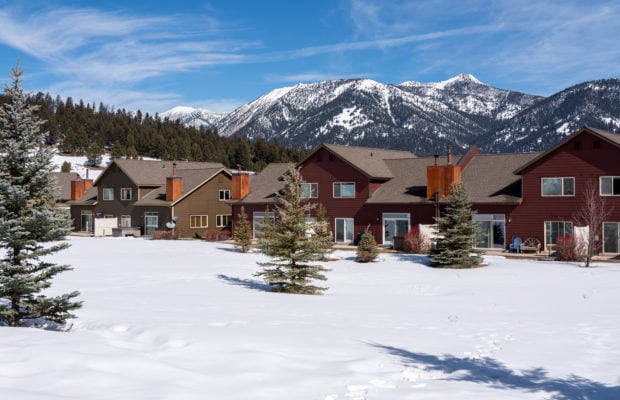 79 Starlight Drive - common space behind condo unit with snow, trees, and mountain views