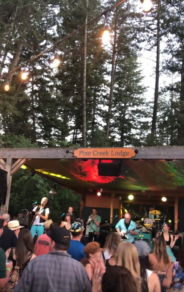 outdoor stage featuring a live band and standing audience at the pine creek lodge