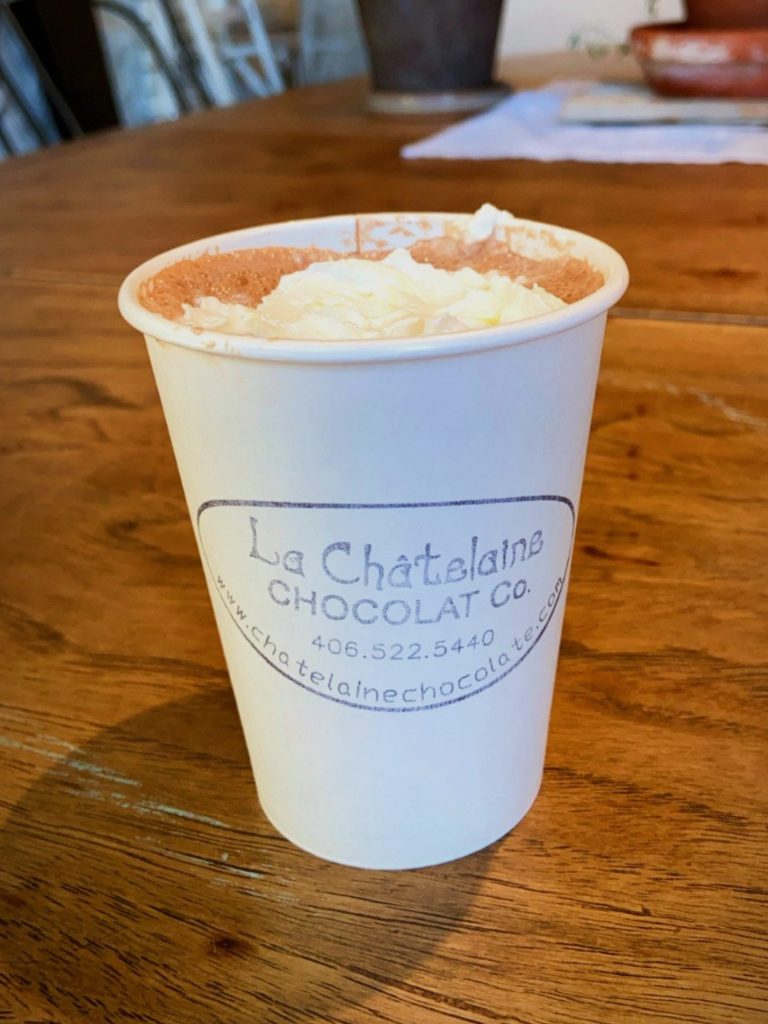 a to-go cup of hot cocoa from le chatelaine in bozeman