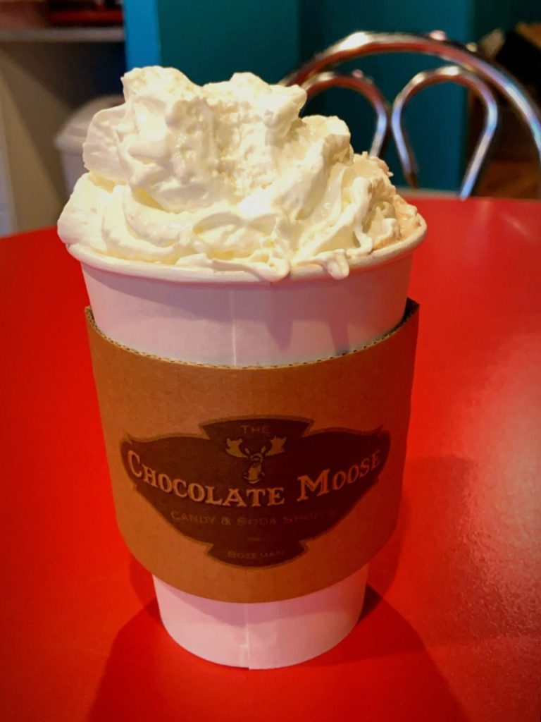 a to-go cup of hot cocoa from chocolate moose in bozeman