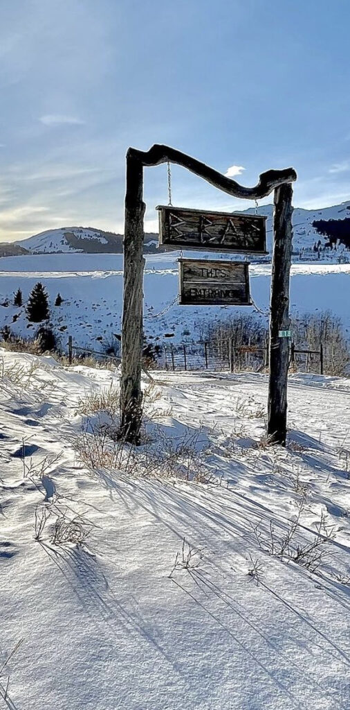 sign for b bar ranch in the snow