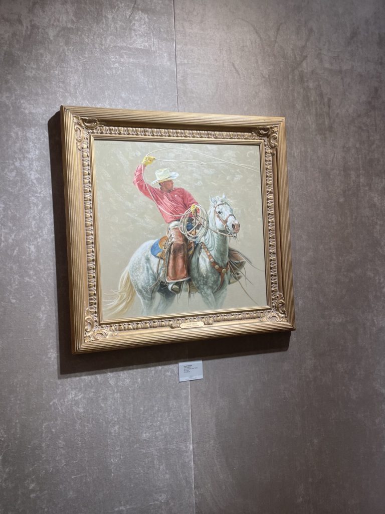A painting of a cowboy on a horse as seen on display at Montana trails Gallery and Bozema