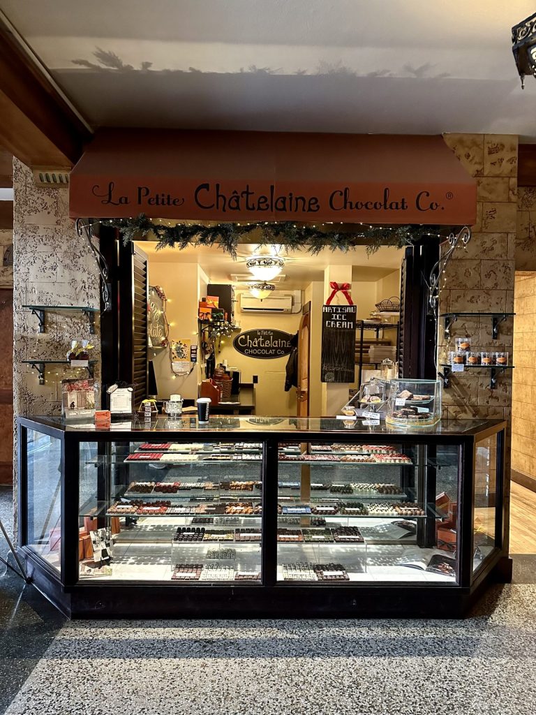 Photo of the kiosk where La petite Chatalaine chocolate Co. is inside of the historic Baxter hotel lobby