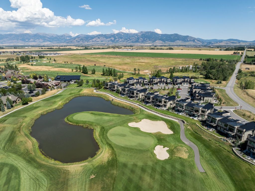 89 Duckhorn Lane, Unit D, drone photo of property and surrounding area including golf course greens and pond