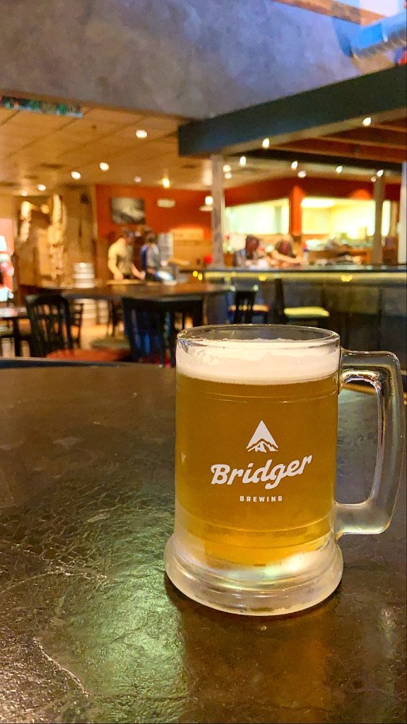 Stein full of beer on a table inside of Bridger brewing