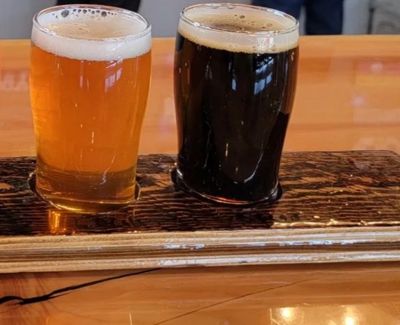 Two small glasses of beer inside of last best Place brewing