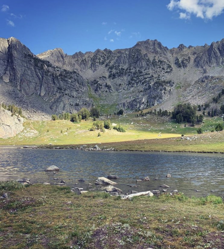 view of alpine lake at the end of beehive basin trail